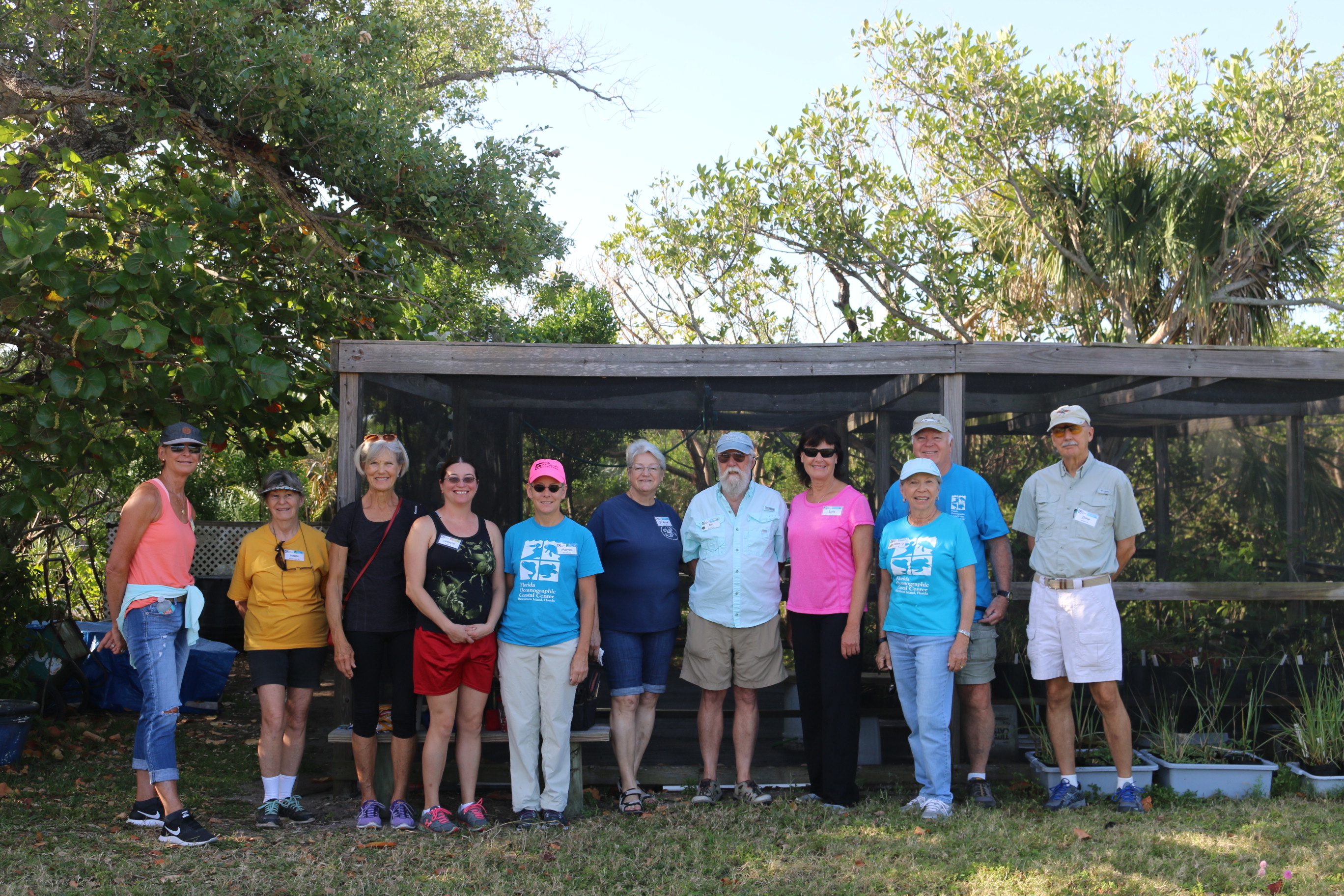 Green team volunteers outside of the greenhouse