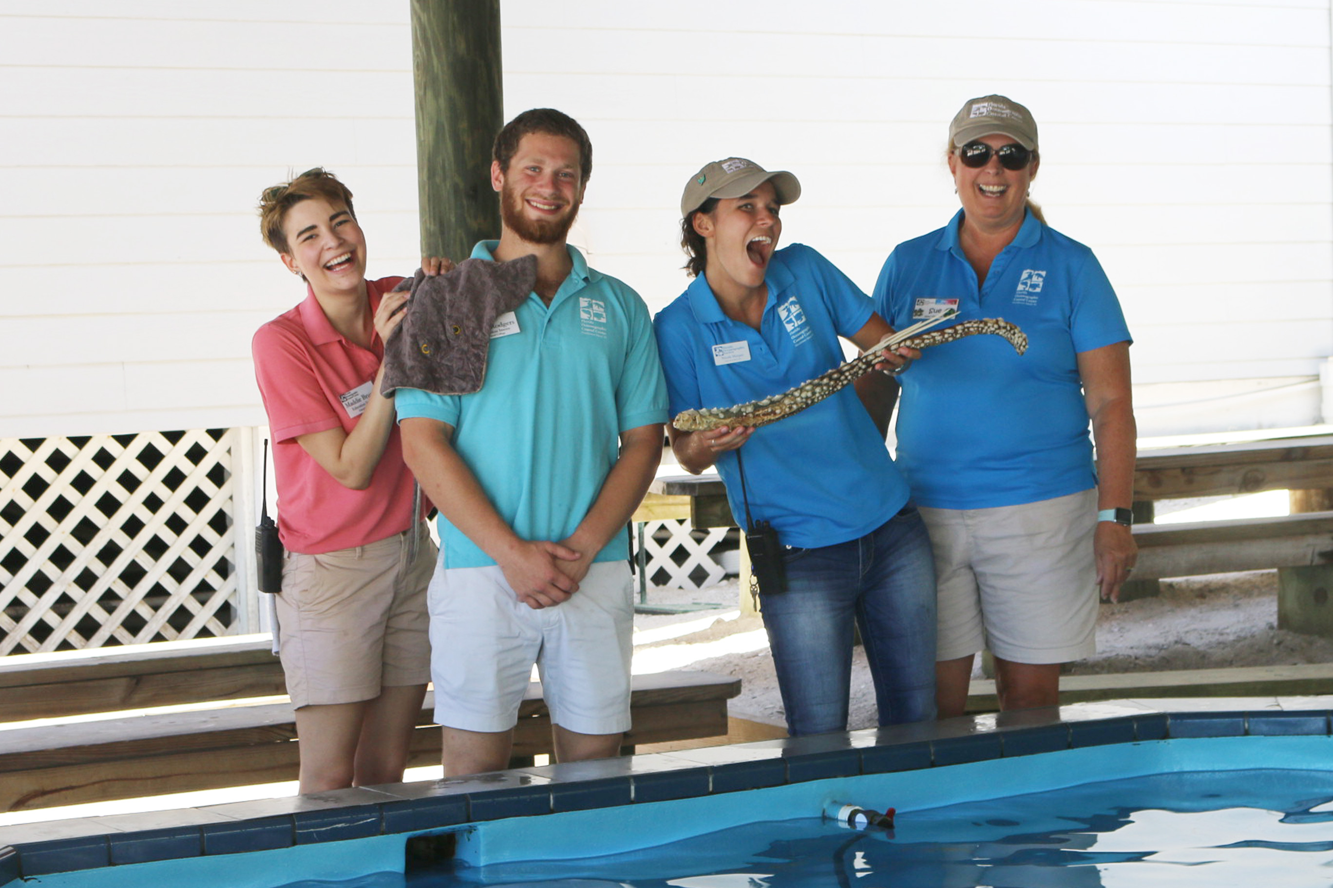 Education interns with education staff and volunteer
