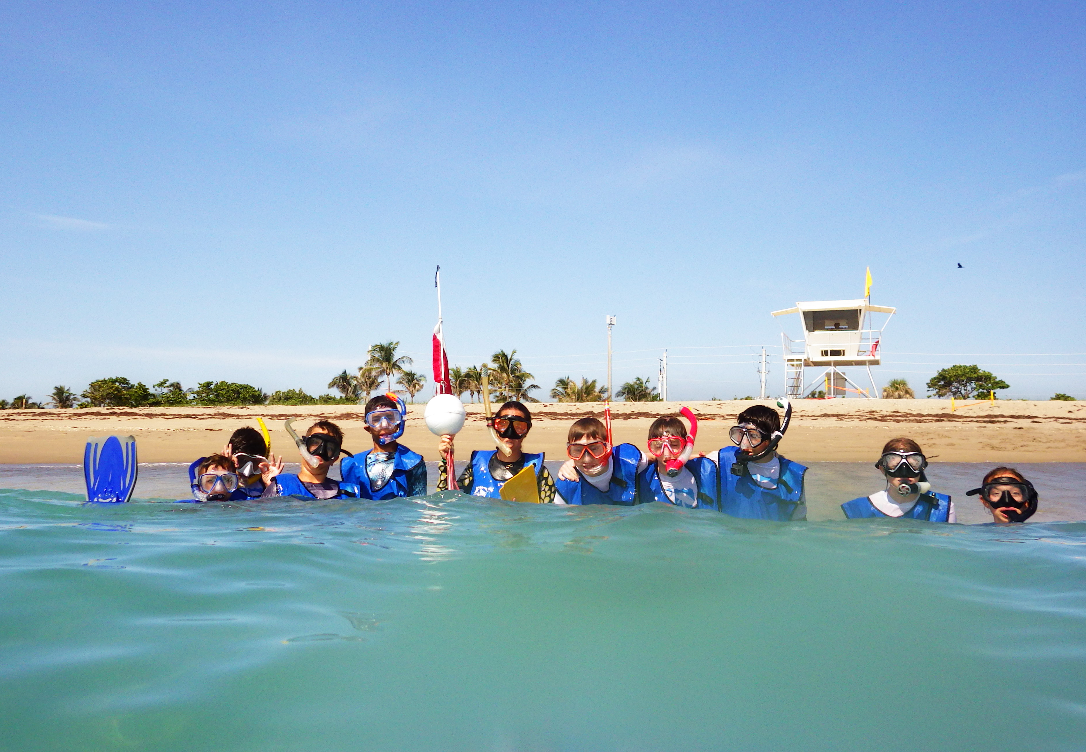 summer campers at the beach in the water 