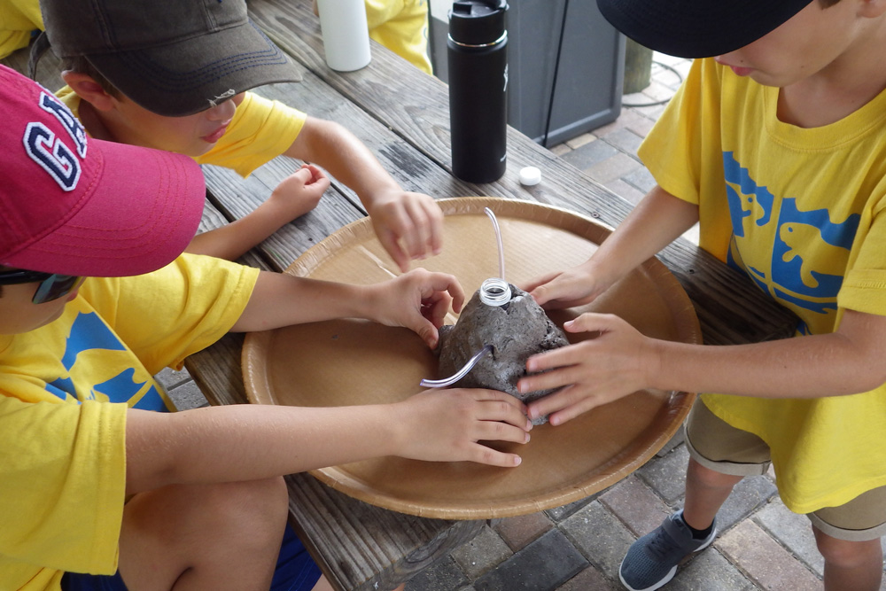 Summer campers doing a science experiment
