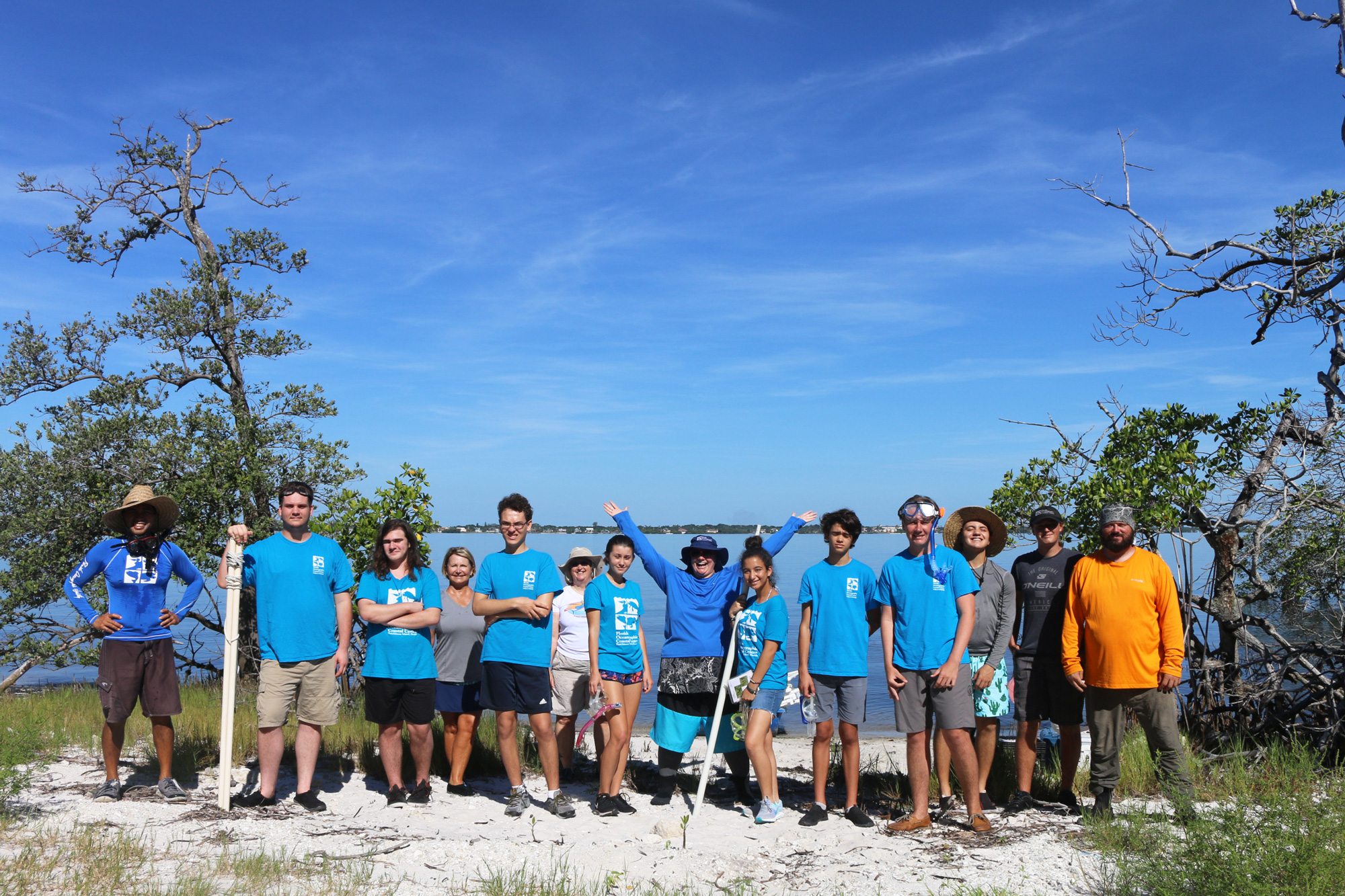 Teen volunteers standing in front of the lagoon